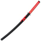 The 41” overall katana slides smoothly into a black lacquered wooden scabbard, accented with red cord-wrap