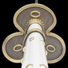 The hardwood handle is wrapped in genuine, white leather with gold stud accents and the tsuba is metal alloy in a gold circular design
