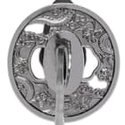 Each of the razor-sharp blades is crafted of high carbon steel, extending from a brass habaki and a cast metal tsuba