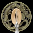 It has a sharp, 28 3/10” 1045 carbon steel, burned blade, extending from a Chinese dragon-themed brass tsuba