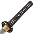 Shinwa samurai sword with direct view of faux ray skin handle wrapped with black cord attached to a wing design tsuba
