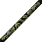 Detailed view of the bright green and white dragon design along the side of the black scabbard. 