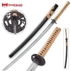 Individual parts of japanese sword showcasing a hand forged damascus steel, zoomed view of cast macque monkey tree tsuba, black scabbard with tan cord wrapped handle and ray skin
