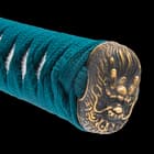 The hardwood handle is wrapped in genuine rayskin and green cord, featuring an antiqued brass dragon head pommel