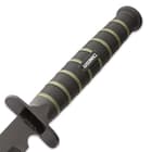 Zoomed view of the sword’s rubberized injection molded handle with textured grip that has “USMC” printed in the middle.