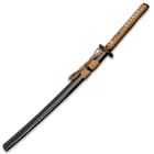 The hardwood handle is wrapped in genuine, tea-colored rayskin and brown cord and features brass dragon menuki