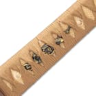 The hardwood handle is wrapped in genuine, tea-colored rayskin and brown cord and features brass dragon menuki