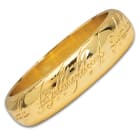 Included with helm is a reproduction of the the One Ring with the actual inscription, crafted in gold-plated metal