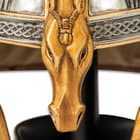 The steel helm features a brass horse head nose guard extending across the crest and engraved horse and sun motifs