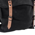 It’s made of black, 100 percent cotton canvas with an adjustable nylon webbing shoulder strap and leather straps