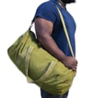It’s made of olive drab, 100 percent cotton canvas with a metal zipper running its length to secure the large, main compartment
