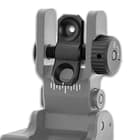 An integrated, windage elevation adjustment wheel provides tool-free adjustment of the dual aperture sight