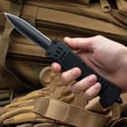 Closed automatic pocket knife with matte black TPU handle that is heavily textured. 

