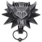 Meticulously cast in the shape of a wolf head, it has a high-quality resin construction with a metal door knocker