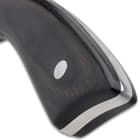 The smooth, black pakkawood handle scales are secured to the tang with heavy-duty stainless steel pins