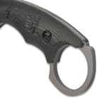 It has a 5 1/2” upswept, modified cleaver blade with a matte-grey finish with a finger choil and an extended open-ring tang
