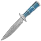 The knife has a keenly sharp, 7 1/4” Damascus steel blade, extending down from a hefty Damascus steel handguard