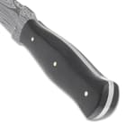 The handle scales are crafted of genuine black horn and are secured to the tang with brass pins