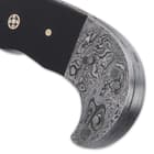 The curved Damascus steel handle has walnut wood handle scales, accented with mosaic rosettes and brass pins