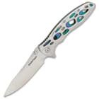 The knife has a keenly sharp, 3 3/4” stainless steel blade, which can be deployed with either the flipper or a thumbstud