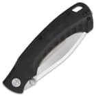The black G10 handle scales have CNC shaped grooves for a slip-free grip and the liners are bead-blasted stainless steel
