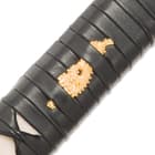 Close view of leather wrapped handle with genuine rayskin and brass menuki attached
