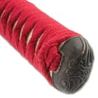 The hardwood handle is wrapped in genuine rayskin and then wrapped in red cord with decorative menuki