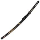 The 41” katana slides into a black lacquered wooden scabbard, accented with a hand-painted dragon and black cord-wrap