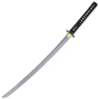 The katana has a razor-sharp, 26 3/4” 1045 carbon steel blade, which extends from polished brass habaki