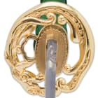The handle is wrapped in genuine white rayskin with green cord-wrapping and the gold-toned tsuba is cast iron
