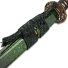 The 41” overall katana slides securely into a black lacquered wooden scabbard, which has a green splatter-print accent and matching cord-wrap