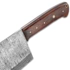 The wooden handle scales are secured to the Damascus steel blade with brass pins.