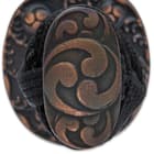 The hardwood handle is wrapped in genuine ivory-colored rayskin and black cord and the round tsuba has a gankyil design