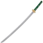 A samurai sword with 27 inch damascus steel blade extended from a brass habaki and rayskin wrapped handle in green nylon cord
