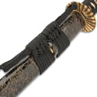 The 41” overall katana slides securely into a black lacquered wooden scabbard, which has a gold spiderweb design and matching cord-wrap