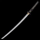 The high-quality katana has a 27 3/8”, keenly sharp Damascus steel blade, which extends from a brass habaki