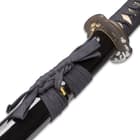 The glossy black hardwood scabbard has a braided black hanging cord. 