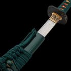 The 40” overall katana slides smoothly into a black, lacquered scabbard, accented with teal cord-wrap to match the handle