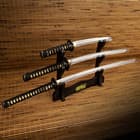 Three piece Japanese sword set with T10 steel blades displayed on a black wooden stand
