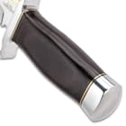 The knife’s handle is made of hardwood and has a polished stainless pommel.