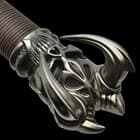 Zoomed view of finely detailed cast metal hilt with a dark iron metal finish
