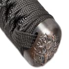 The black cord of the handle wraps through the antique finished pommel. 