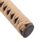 The black genuine ray skin handle is wrapped in tan braided cord. 