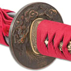 The brass tsuba has a swirling dragon design. 