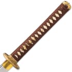The hardwood handle is wrapped in genuine rayskin and brown cord, featuring brass dragon menuki and a brass twin dragon pommel