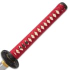 The hardwood handle is wrapped in genuine rayskin and then wrapped in red cord with decorative menuki
