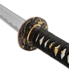 The hardwood handle is wrapped in faux rayskin and black cord and has an intricately detailed metal alloy tsuba