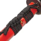 The brightly colored scabbard has a black hanging cord. 