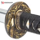 The tsuba is brass with bamboo and floral detailing. 