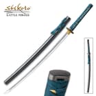 A katana steel blade sword with teal cord wrapped round tea dyed rayskin with zoomed view of black pommel encased in a black scabbard
